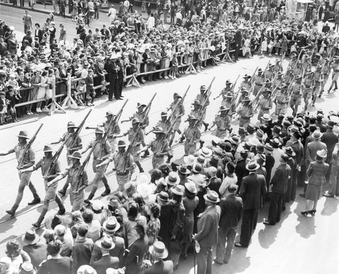 Soldiers marching through Melbourne streets, watched by large crowd, c. 1941