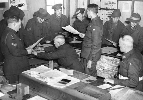 Dischargees signing papers at S.D.D. Royal Park, c. 1944