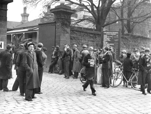 Men gathered outside Victoria Barracks in St. Kilda Road shown from the roadway, 1936–42