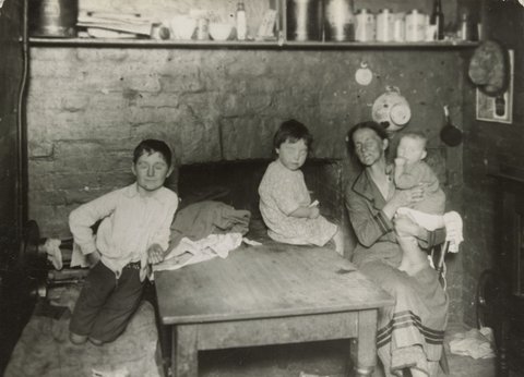 Carlton [Kitchen interior with woman and three children], c. 1935