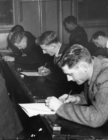 Students at Melb. Tech. [i.e. Melbourne Technical School] do theory exam in "A" grade Motor Mechanics, c. 1946