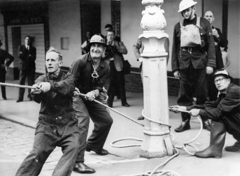 Air Raid Precautions Squad during display in Melbourne - pulling an unseen patient to ground, c. 1943