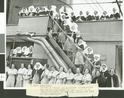 Melbourne. Victorian nurses and masseuses accompanying the second contingent of the A.I.F. to go abroad watching the men file aboard the ship at Port Melbourne, 1940?