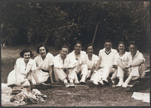 Tennis team four women four men sitting on lawn at staff tournament in St. Kilda from Bourke Street Store No. 4, 1939