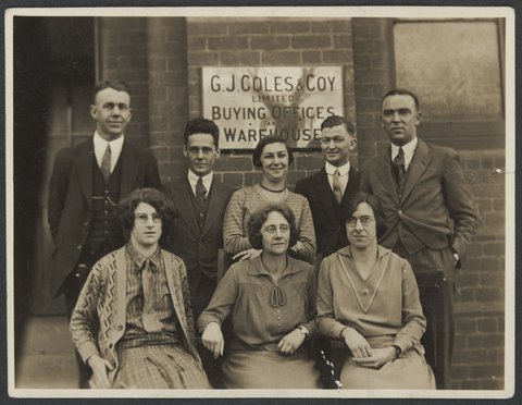 Buying Offices staff four women and four men in two rows front of Collins Street building, 1930–35