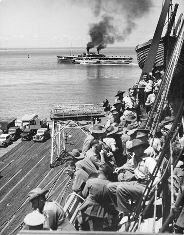 The Weeroona paddle steamer sails around the troopship carrying the 2nd A.I.F. men from Port Melbourne, c. 1941