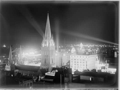 St. Paul's Cathedral towers, Swanston Street and Yarra River looking south-west, also shows Nicholas building illuminated for Victoria's Centenary celebrations, 1934–35