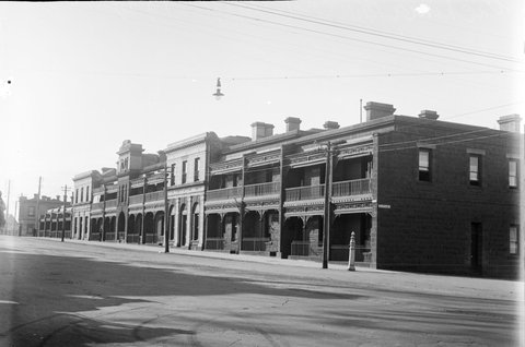 View of Queen Street, looking North from the corner of A'Beckett Street showing Victoria Buildings - a row of bluestone terrace houses, 1911–35